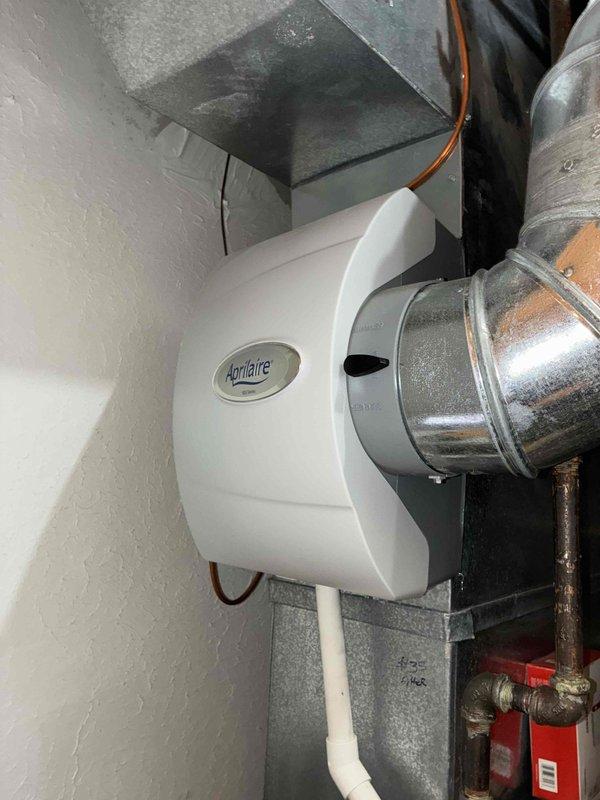 Performed heating tune-up on two older HVAC systems. Conducted electrical measurements with UEi G2 PHOENIX multimeter to verify proper voltage and current readings. Inspected Aprilaire whole-home humidifier installation and connection to ductwork, confirming all components were in good working condition.
