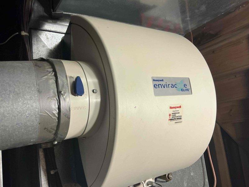 Conducted full system assessment of aging HVAC unit with functioning heat. Inspected Honeywell Enviracaire Elite component and TRU-AIR system. Documented existing installation including metal ductwork, insulation integrity, and PVC ventilation components to prepare comprehensive replacement options.