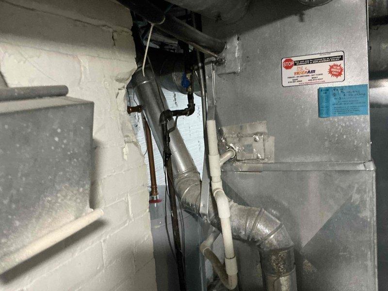 Conducted full system assessment of aging HVAC unit with functioning heat. Inspected Honeywell Enviracaire Elite component and TRU-AIR system. Documented existing installation including metal ductwork, insulation integrity, and PVC ventilation components to prepare comprehensive replacement options.