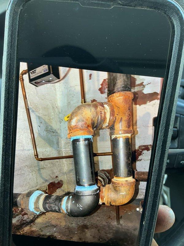 Replaced deteriorated black iron pipe sections in utility area where significant corrosion was present at multiple connection points. Installed new piping with proper fittings and seals to address water damage risks and restore system integrity.