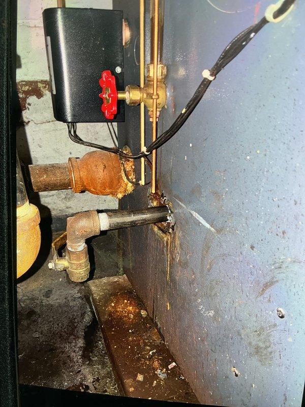 Replaced deteriorated black iron pipe sections in utility area where significant corrosion was present at multiple connection points. Installed new piping with proper fittings and seals to address water damage risks and restore system integrity.