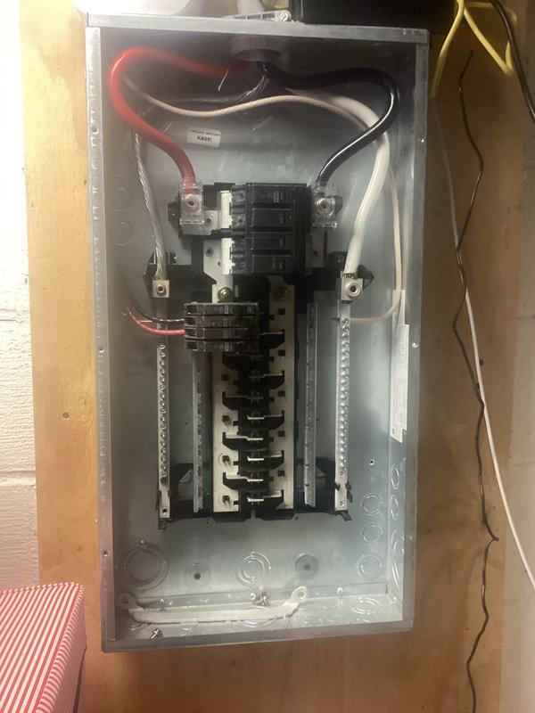 Performed comprehensive electrical panel inspection, examining interior components of breaker box with cover removed. Verified proper wire connections, breaker functionality, and overall panel condition. All circuit breakers and wiring (including red, black, white, and green conductors) appeared properly installed with no visible damage or safety concerns noted.
