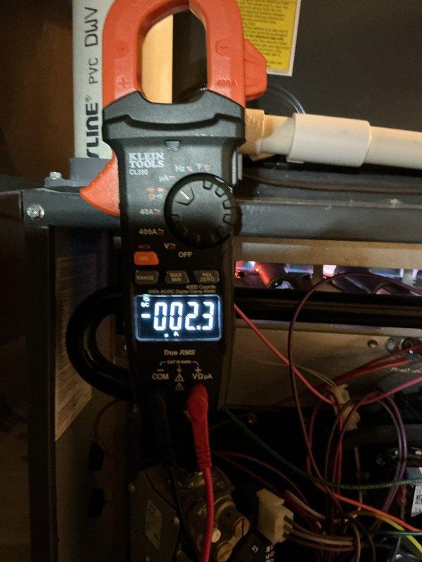 Responded to no-heat emergency call for gas furnace less than 5 years old. Diagnosed frozen condensate line causing system shutdown; multimeter reading confirmed proper voltage at 0.23 amps. Thawed ice formation at exterior drain outlet, cleared condensate line, and restored normal system operation.