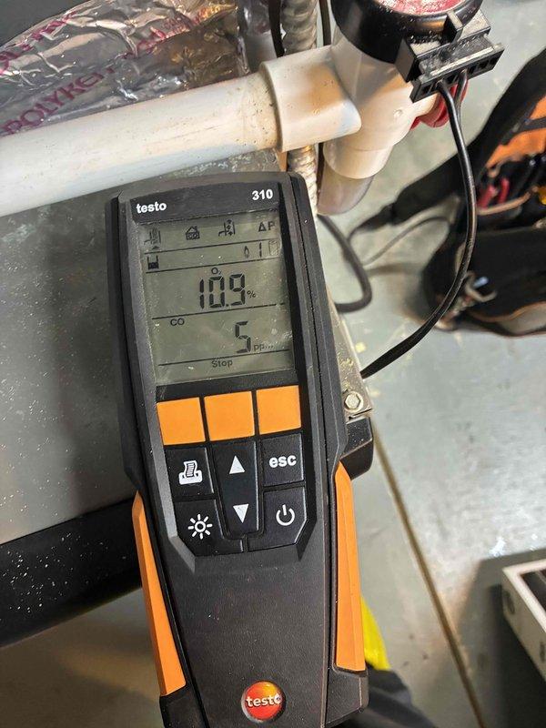 Performed scheduled heating tune-up service. Inspected heat exchanger fins for proper condition and alignment. Conducted combustion analysis using Testo 310 analyzer, confirming proper operation with readings of 10.9% and 5 ppm, indicating efficient combustion within specifications.