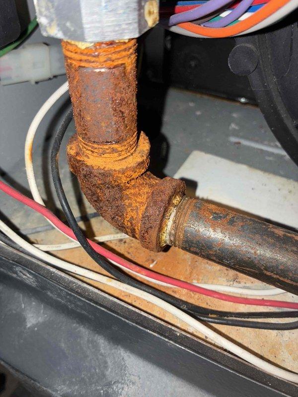 Performed routine maintenance on 7-year-old furnace per maintenance agreement. Discovered significant corrosion on heat exchanger pipe connections and inspected electrical wiring, noting several wires passing through a grommet with normal wear. Documented findings with photos and advised customer of corrosion concerns requiring future attention.