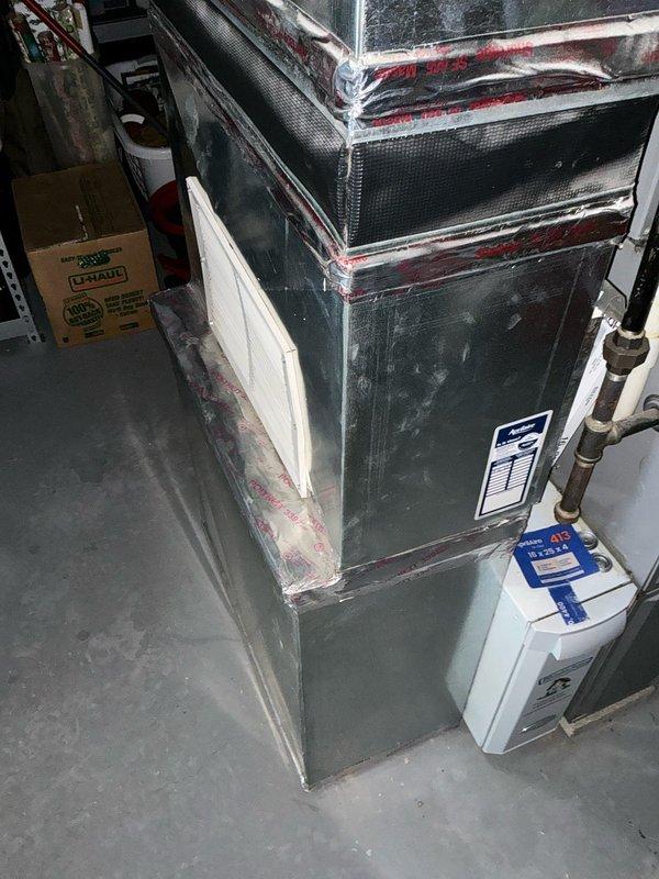 Conducted inspection of customer's furnace system and identified significant rust formation on the heat exchanger. Documented the current installation setup including the air handler unit in the basement/utility room and associated ductwork, electrical connections, and PVC piping. Presented replacement options to customer Jerrell due to the compromised heat exchanger condition which poses potential safety and efficiency concerns.