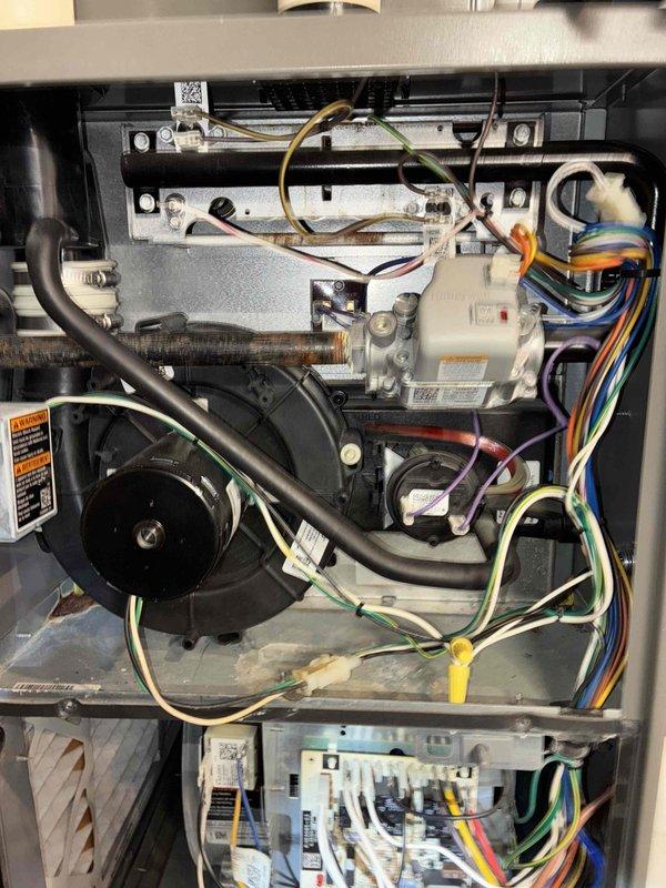 Performed scheduled monthly heating maintenance on residential HVAC system. Inspected electrical connections at control panel and verified proper wiring integrity. Examined blower motor assembly and internal components for normal operation with no issues detected.