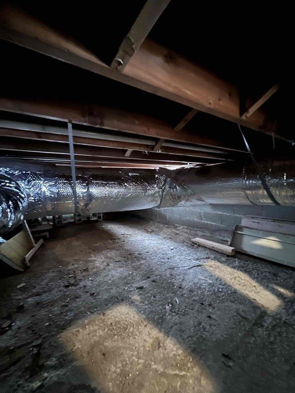 Completed relocation and re-insulation of flexible ductwork in crawl space area, securing all seams with reflective tape to ensure proper thermal efficiency. Successfully wired low voltage connections to HVAC unit according to manufacturer specifications and verified system operation.