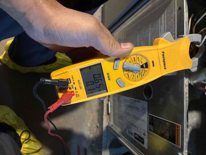 Performed monthly heating maintenance service on HVAC system. Conducted electrical diagnostics using Fieldpiece SC260 clamp meter, confirming proper voltage reading of 29.5. Inspected blower motor assembly, verifying all wiring connections (green, white, red, and blue) were secure and properly terminated.