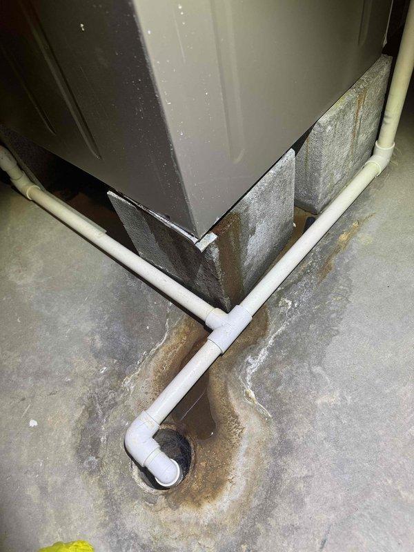 Responded to no heat service call for system blowing cold air. Inspection revealed condensate drain issues with visible mineral buildup and water staining around floor drain. Serviced the heating system components and cleared blockage in drainage system to restore proper operation.