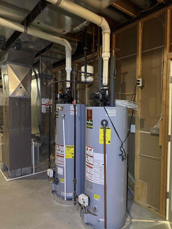 Responded to no heat service call for system blowing cold air. Inspection revealed condensate drain issues with visible mineral buildup and water staining around floor drain. Serviced the heating system components and cleared blockage in drainage system to restore proper operation.