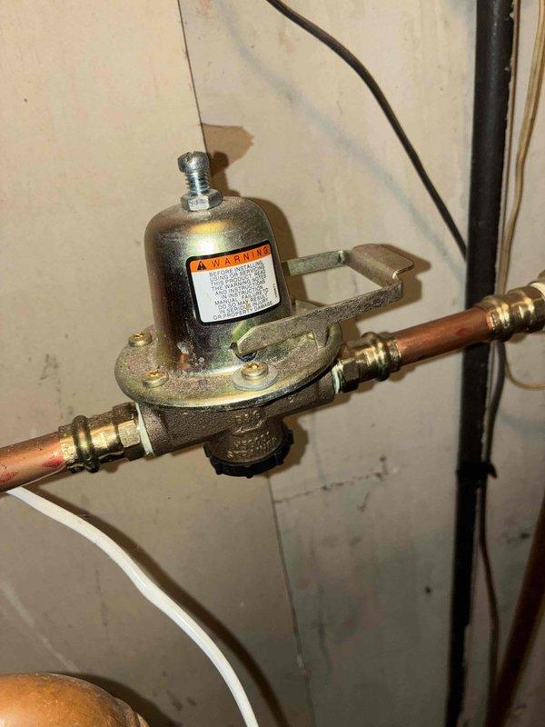 Responded to no-heat emergency call at residential property. Upon inspection, identified failed pressure regulator valve on boiler system. Replaced defective valve, purged air from system, and verified proper operation. System now maintaining appropriate pressure and producing heat effectively.