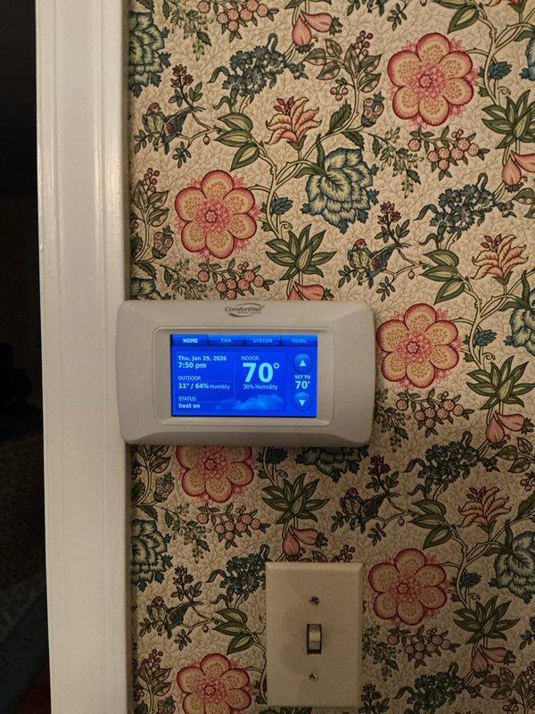 Responded to customer complaint regarding thermostat displaying "low batteries" and "replace sensor" messages. Inspected Carrier digital thermostat showing normal temperature (70°F) and humidity (41%) readings. Replaced batteries and tested system functionality, confirming proper operation with no further error messages.