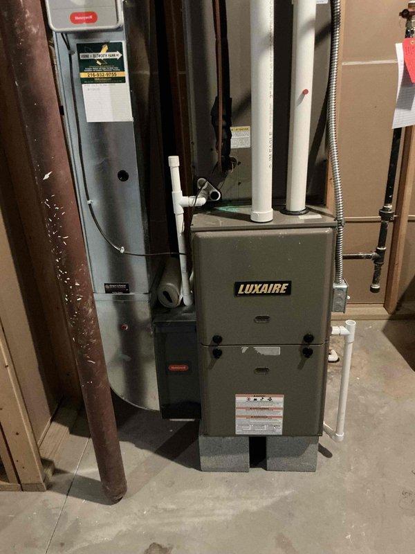 Diagnosed non-functioning bedroom heating system, finding a cracked secondary heat exchanger in the existing Luxaire furnace. Presented replacement options for the unit, noting this is one of two HVAC systems in the home, specifically servicing the bedroom areas.