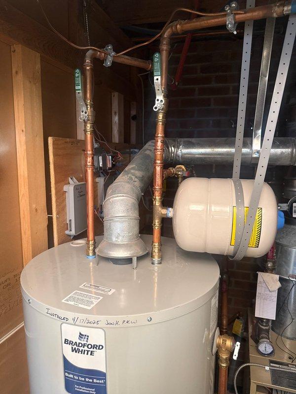 Returned to premises to replace water heater fill tube as scheduled. Verified proper installation and connection of Bradford White water heater system, including expansion tank, copper supply lines, and ventilation duct. All components functioning correctly after service completion.