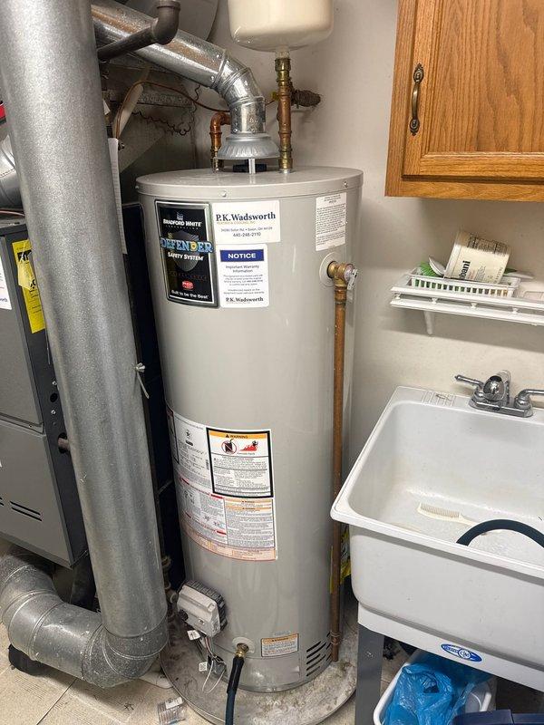 Performed scheduled maintenance on Bradford White tanked water heater. Replaced water filter as requested. Inspected expansion tank, copper/brass fittings, and ventilation system - all components in good working condition with no leaks or damage observed.
