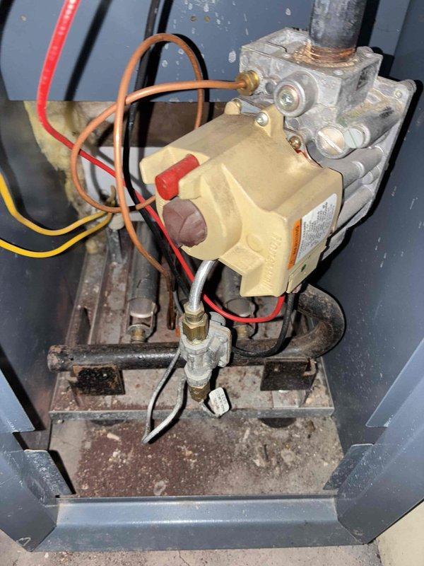 Performed scheduled heating maintenance service on residential HVAC system. Inspected gas valve and associated wiring connections, noting minor corrosion on mounting brackets. Observed rust development on equipment housing near ground wire connection point that will require monitoring but is currently functioning properly.