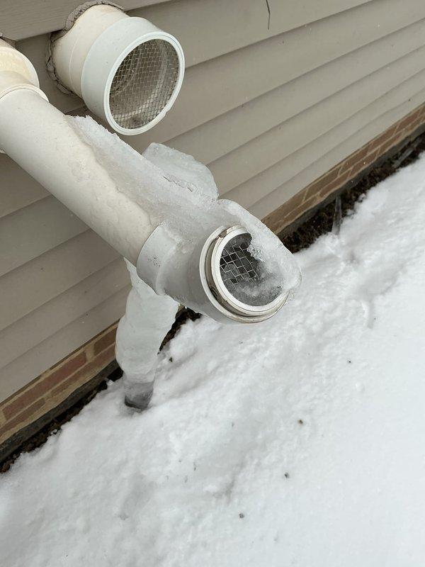 Responded to no-heat call for recently installed 6-month-old furnace. Inspection revealed severe ice formation on exterior PVC exhaust venting, with icicles extending several feet from the termination point. Cleared ice blockage from vent pipes to restore proper exhaust flow and system operation.