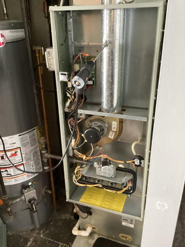 Performed comprehensive maintenance on aging heating system (10+ years old). Conducted full inspection of furnace interior components, revealing all connections and wiring intact. Measured static pressure with UEi EM152 gauge showing 36.0 reading, indicating system is operating within acceptable parameters despite age. Addressed intermittent odor issue by cleaning internal components and recommending regular filter replacement schedule.