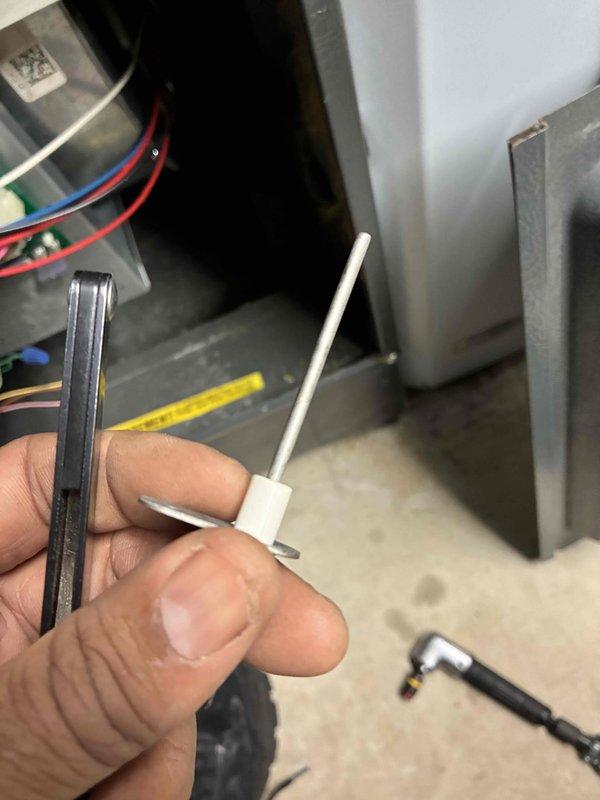 Performed comprehensive heating tune-up on aging system (10+ years). Inspected ignition components and flame sensor, testing electrical connections for proper operation. Measured supply air temperature (68.9°F) to verify system performance within expected parameters for unit age.