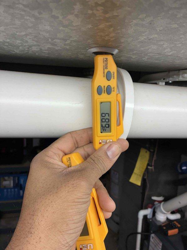 Performed comprehensive heating tune-up on aging system (10+ years). Inspected ignition components and flame sensor, testing electrical connections for proper operation. Measured supply air temperature (68.9°F) to verify system performance within expected parameters for unit age.