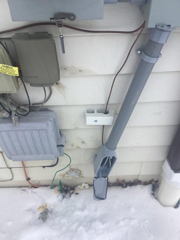 Responded to service call regarding ice formation on interior breaker panel. Upon inspection, discovered improper exterior electrical service entrance installation with open junction box and compromised conduit sealing, allowing moisture penetration into the basement electrical panel. Sealed exterior service entrance components and repaired weatherproofing to prevent further water intrusion and ice formation on interior electrical equipment.
