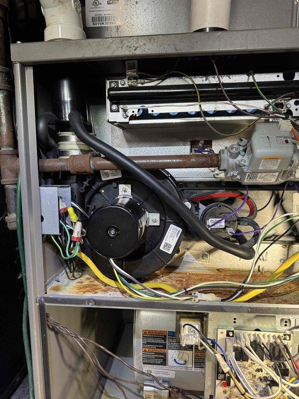 Responded to no-heat service call for an aging furnace system. Upon inspection, discovered blower motor failure with visible corrosion at the base of the unit. Replaced defective motor, cleaned electrical connections, and restored system operation after comprehensive testing to ensure proper heating function.