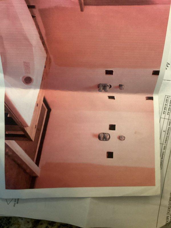 Replaced faulty Kohler shower mixing valve in bathroom renovation. Installed new valve assembly and verified proper hot/cold water mixing functionality. Final installation completed with brushed nickel trim kit on gray solid surface shower enclosure.