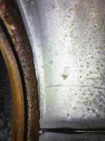 Performed routine heating maintenance on a 10+ year old gas furnace located in basement. Inspection revealed significant rust and corrosion on critical components, with evidence of moisture accumulation at material junctions. System showing advanced age-related deterioration that may affect operational efficiency and safety.