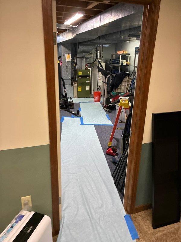 Completed installation of a new 80% efficiency furnace and AC system with duct liner. Installation area was properly prepared with protective coverings on floors and staircase to maintain cleanliness of the residence. All components were successfully installed in the basement mechanical room with appropriate connections to existing utility infrastructure.