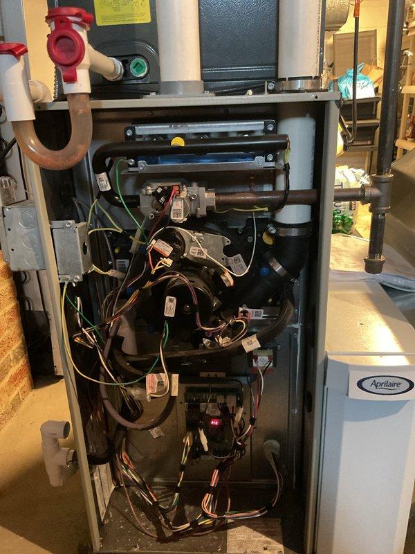Performed routine maintenance service on 4-year-old gas furnace. Inspected internal components including electrical connections, wiring harness, and control board on Aprilaire system. Examined ventilation system with PVC intake/exhaust pipes and verified proper operation of attached humidifier unit. All systems functioning normally; no issues identified.