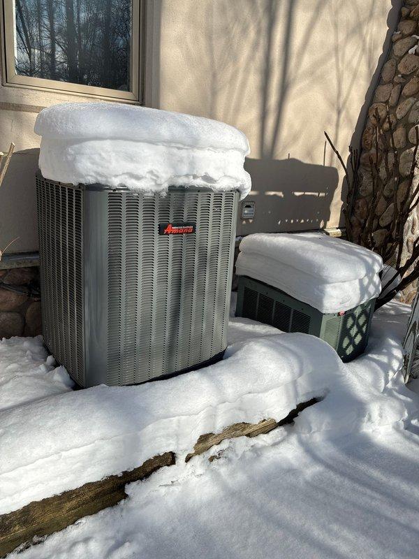 Performed assessment for heat pump system replacement on a residential property with 4 existing heat pump systems. Inspected current installation which showed two Amana units with significant snow accumulation. Evaluated existing control systems including thermostat connections and humidifier components. Customer is a returning client with two previous projects completed.