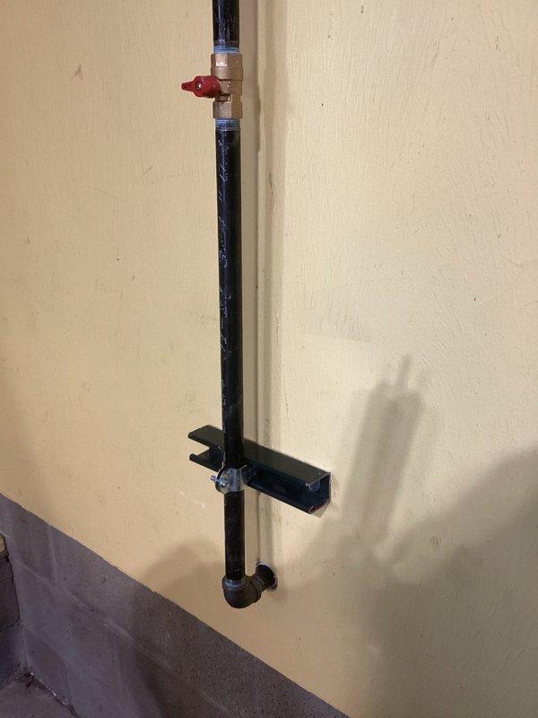 Successfully installed new gas line from basement to garage space heater, properly securing it with channeling for support. Installed a customer-requested shut off valve with brass fitting and red handle to ensure safe gas control. Line was properly mounted to the wall using metal brackets for stability.