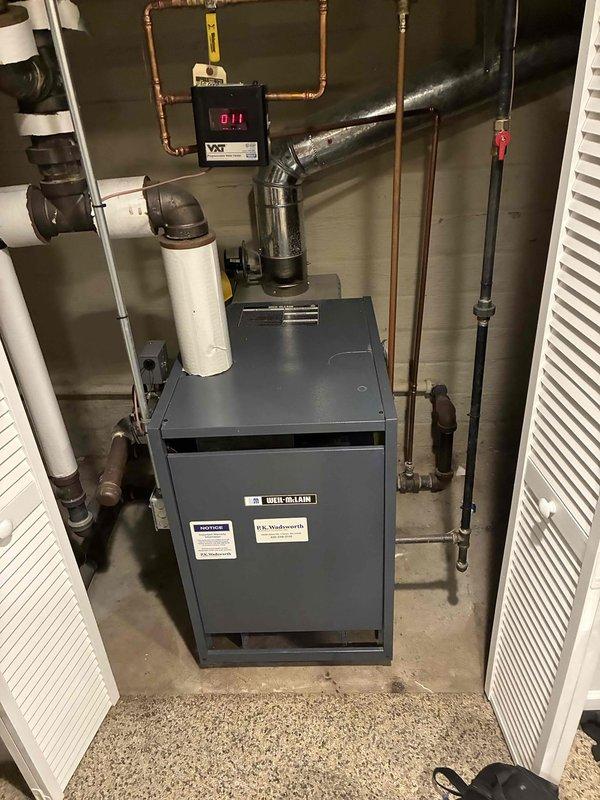 Completed scheduled maintenance on a 6-year-old steam boiler system. Inspected Weil-McLain boiler unit, associated copper piping, and control systems including VXT module. Verified proper operation of brass valve assembly and pressure regulation components.