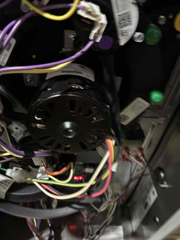 Performed routine heating maintenance service on system. Conducted electrical testing with multimeter to verify proper voltage readings (measured 65V) at control board. Inspected blower motor assembly and wiring connections, confirming all components were properly secured and operational.