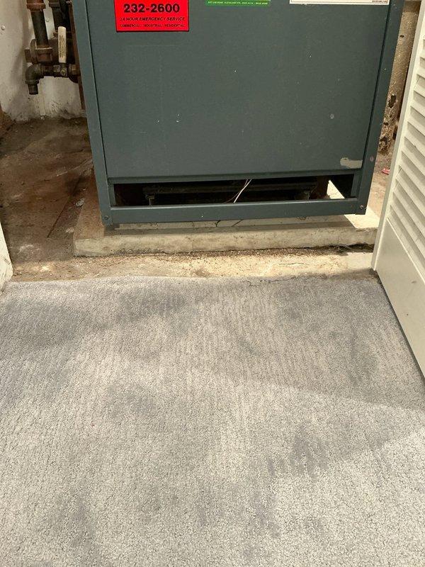 Performed assessment of aging boiler system showing significant corrosion on vertical piping and connection components. Unit inspection revealed a furnace/boiler with visible wear, mounted on deteriorating concrete pad, with panel access issues and compromised copper plumbing connections. Presented customer with replacement options based on evaluation findings.