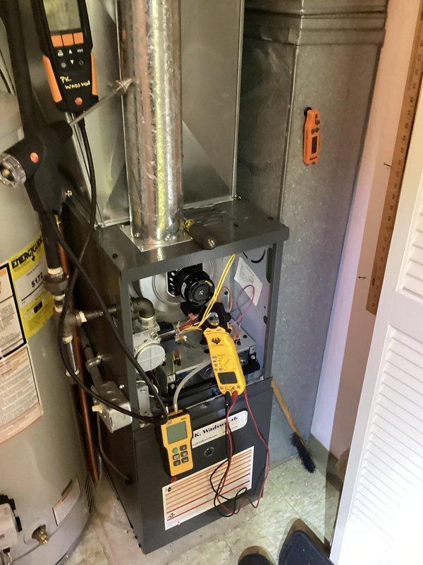 Performed routine furnace maintenance including combustion analysis with Testo 310 meter showing CO2 readings of 28.56 and O2 readings of 1.20. Completed diagnostic testing on the gas furnace system with access panel open to inspect control board and internal components, ensuring proper operation for the heating season.