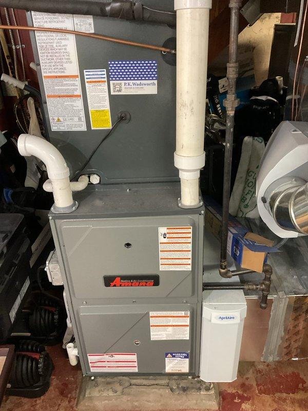 Completed routine heating maintenance on Amana furnace system. Inspected circuit board, wiring connections, and blower assembly for proper function. Examined PVC intake/exhaust piping and verified all components operating correctly.
