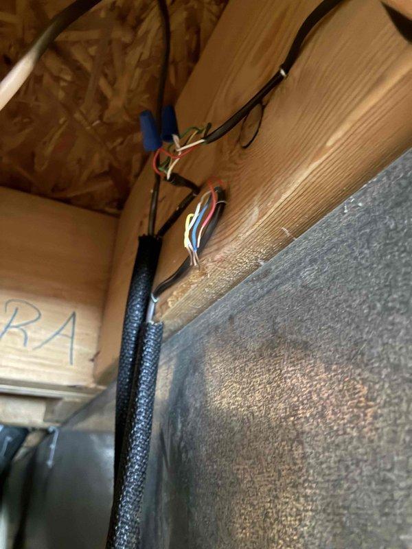 Performed diagnostic assessment on non-functioning Aprilaire humidifier unit mounted to customer's HVAC system. Inspection revealed electrical connection issues at the junction point where multiple wires (blue, red, white) were improperly connected. Repaired wiring connections to restore proper operation of the humidifier system.