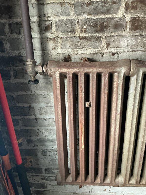 Responded to emergency service call for steam leak. Located and repaired pin hole in cast iron radiator system that was actively releasing steam. Inspected and measured associated components to ensure proper system functionality after repair.