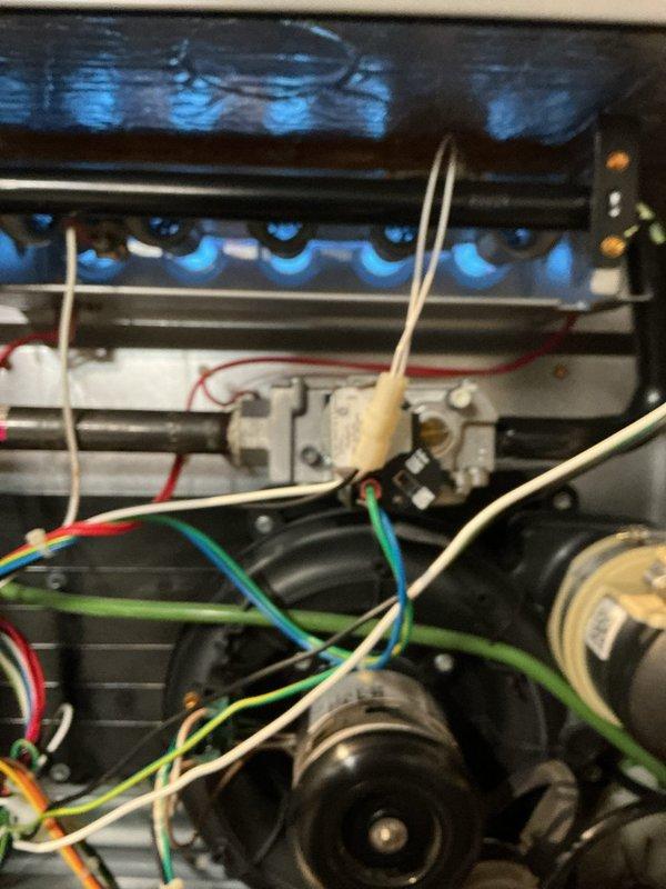 Responded to emergency no-heat call for 5-year-old gas furnace that had previously been serviced. Diagnostic testing with manometer revealed negative pressure readings (-138) at the burner assembly, indicating improper draft/venting issue. Corrected flame sensing issues and verified proper operation of all components, restoring normal heating function.
