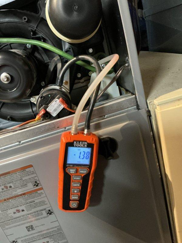 Responded to emergency no-heat call for 5-year-old gas furnace that had previously been serviced. Diagnostic testing with manometer revealed negative pressure readings (-138) at the burner assembly, indicating improper draft/venting issue. Corrected flame sensing issues and verified proper operation of all components, restoring normal heating function.