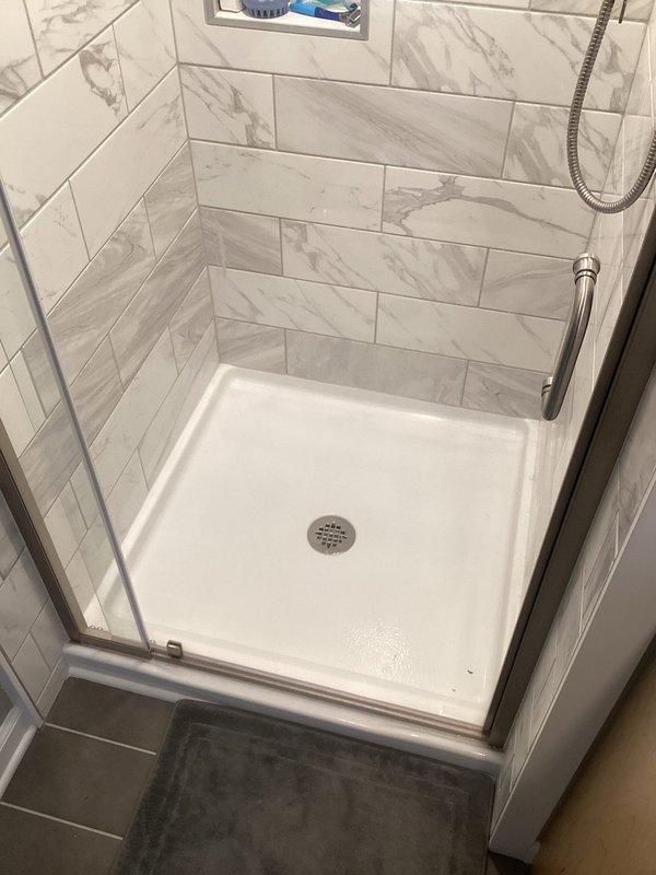 Inspected shower following customer's report of noise occurring after previous shower strainer installation. Visual examination of shower enclosure, drain assembly, and surrounding ceiling revealed no evidence of leaks or mechanical issues related to the previously installed strainer. Confirmed proper drainage and operation of shower system.