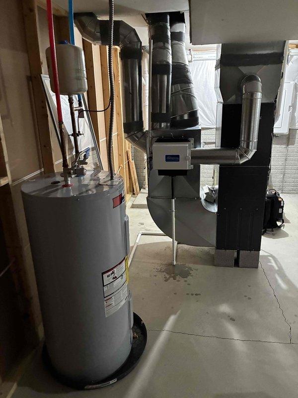 Performed comprehensive furnace system check for new homeowner. Inspected HVAC system components including air handler, ductwork, and water heater connections. Removed and replaced severely soiled air filter which showed significant dust accumulation, restoring proper airflow to the system.