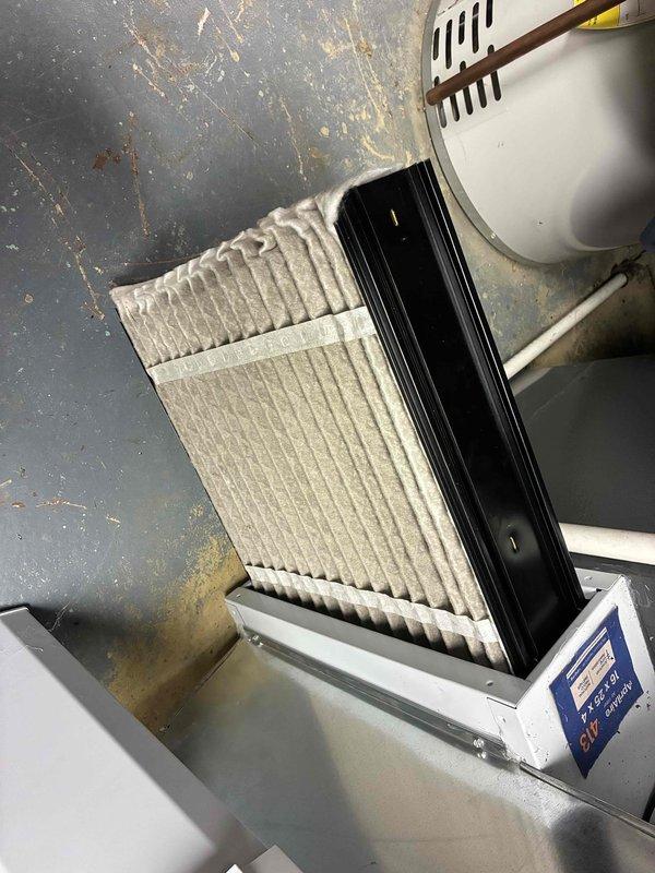 Performed scheduled monthly maintenance on heating system. Inspected and found dirty pleated air filter in need of replacement. Examined Aprilaire humidifier unit and associated ductwork, confirming proper installation and operation of control panel with blue LCD display.