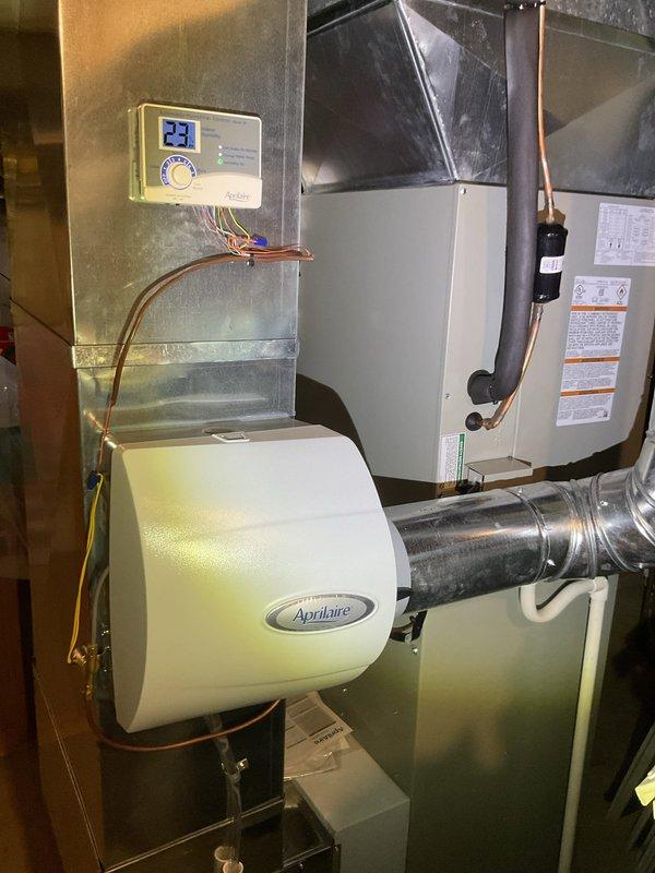 Performed routine heating maintenance on furnace system with Aprilaire humidifier attachment. Inspected all components including ductwork, PVC venting, and digital control panel which displayed normal operation temperature (23°). Changed air filter as scheduled and verified proper system functionality.