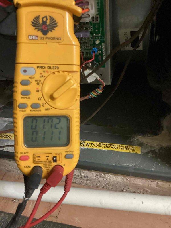 Performed heating maintenance inspection on system with reported humidifier issues. Conducted electrical testing with multimeter on control board to diagnose humidifier water flow problem. Inspected blower wheel assembly, noting dust accumulation on components.