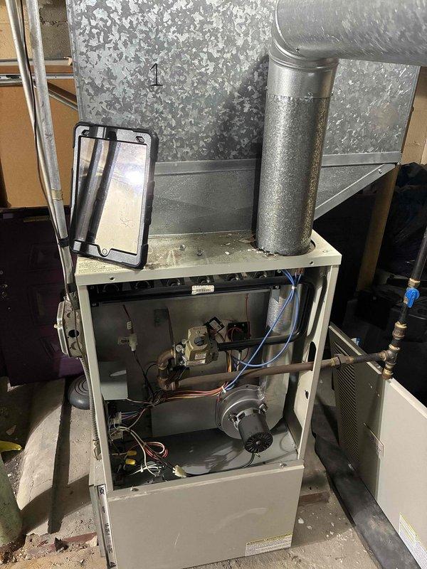 Responded to service call for sanctuary furnace not heating. Performed diagnostic inspection of Concord furnace system, removing access panel to examine internal components. Documented equipment specifications for future commercial maintenance agreement, including main furnace unit and associated ventilation system with proper filtration requirements (20x25).