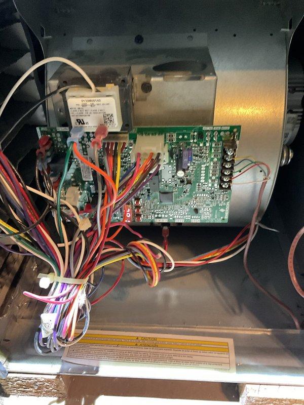 Performed routine heating maintenance on Goodman furnace system. Inspected circuit board connections and wiring harness integrity within control panel. System is functioning properly with all components in good working condition.