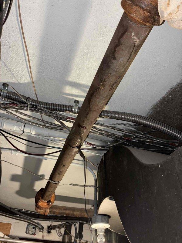 Responded to customer-reported boiler leak. Inspection revealed significant corrosion and oxidation on multiple pipes in the boiler system, particularly on copper and iron components. Observed deterioration at pipe joints and ceiling penetrations with evidence of long-term moisture exposure. Identified mixed materials from previous repairs contributing to system vulnerability.